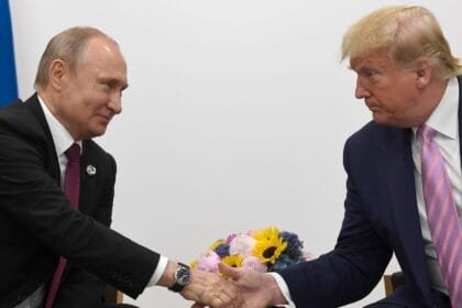 Trump shakes hands with Putin