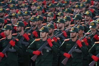 Iran's Revolutionary Guard announces its readiness to respond to America and Israel amid escalating tensions.