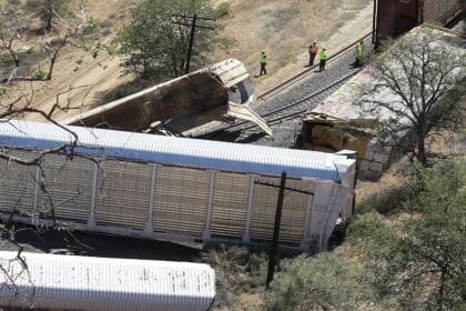 A freight train derails and throws flammable vehicles into an American river.