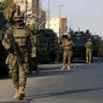 Iraqi security forces shoot down a drone carrying explosives in the skies over Basra.