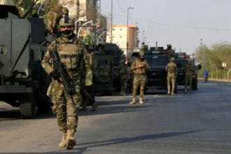 Iraqi security forces shoot down a drone carrying explosives in the skies over Basra.