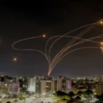 Iranian rocket barrage hits central Israel: Woman injured, street fire breaks out