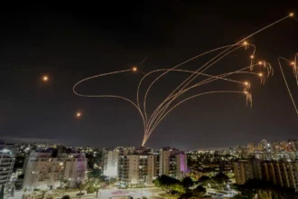 Iranian rocket barrage hits central Israel: Woman injured, street fire breaks out