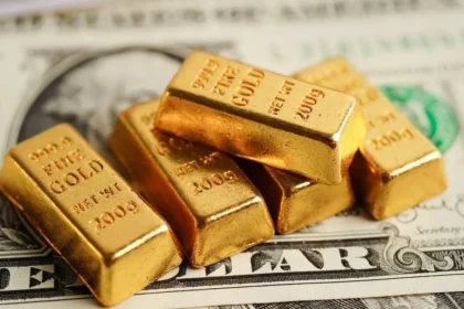 The dollar's decline and falling oil prices are driving gold higher following Washington's recent decisions