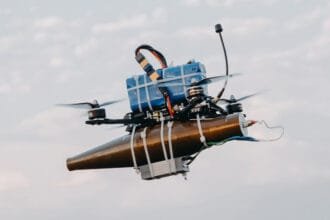 A lightweight drone with an RPG warhead strapped to it using cable-ties