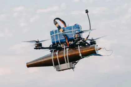 A lightweight drone with an RPG warhead strapped to it using cable-ties