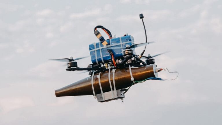 A lightweight drone with an RPG warhead strapped to it using cable-ties