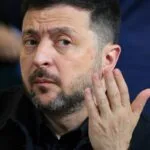 A Ukrainian calls for a popular demonstration in front of Zelensky's office on September 10 amid mounting criticism