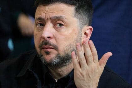 A Ukrainian calls for a popular demonstration in front of Zelensky's office on September 10 amid mounting criticism